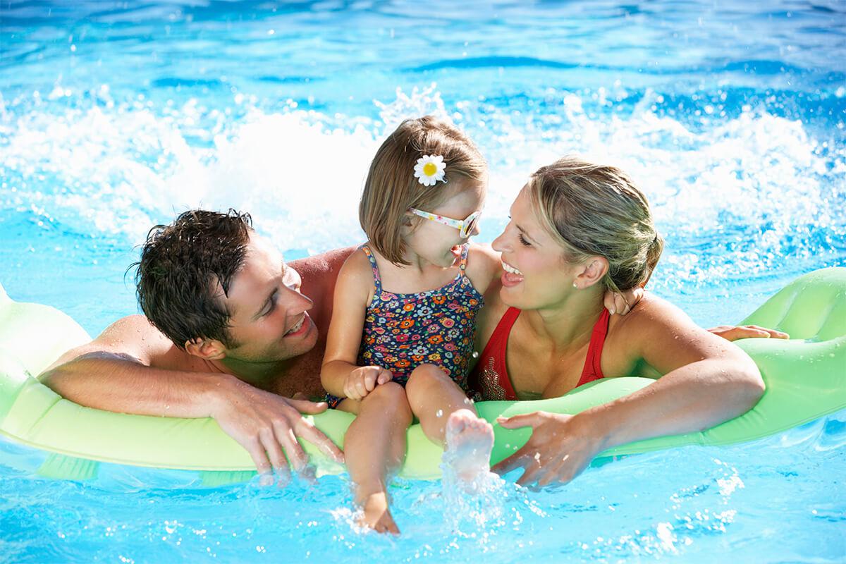 family having fun in the swimming pool iStock-171578745.jpg